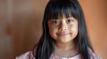 A happy toddler with bangs and long eyelashes smiles for portrait photography photo