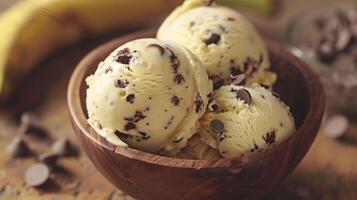 Three scoops of banana chocolate chip ice cream in a wooden bowl photo