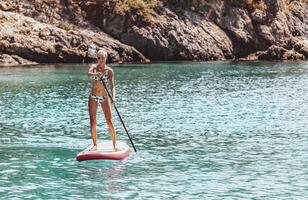 Sportive Girl on the Paddle Board photo