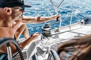 Handsome Sailor Working on Sailboat photo