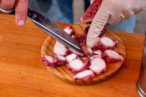 Preparing a portion of pulpo a feira, typical octopus recipe in Galicia, Spain. photo