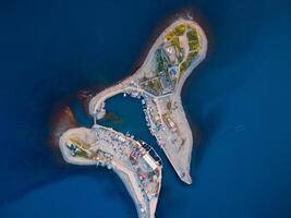 Aerial view of coastline with blue sea, island and lighthouse in Utrish, Anapa photo