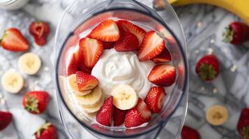 Top-Down View Inside a Blender with Frozen Strawberries photo