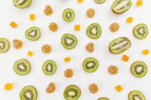 Candied fruit jelly with kiwi fruits on white. Flat lay, top view. photo