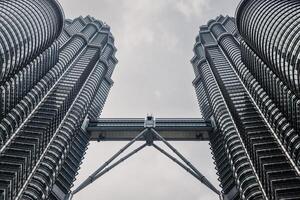 May 25, 2024. Kuala Lumpur, Malaysia. Petronas skyscrapers with bridge, Twin towers in center. photo