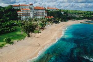 Beach with luxury hotel resort and ocean in Bali island. Aerial view photo
