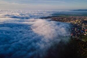 Aerial view with clouds and mountains. Foggy spring weather photo