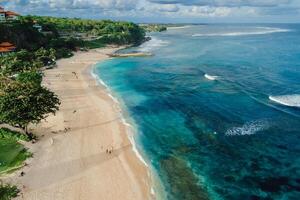 Beach with blue ocean and waves in Bali island. Aerial view photo