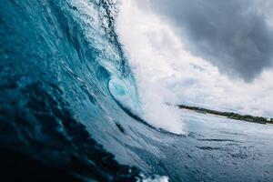 Big ocean blue wave. Breaking barrel wave photo