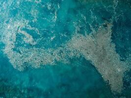 Ocean water and plastic trash island. Aerial view of pollution by rubbish photo