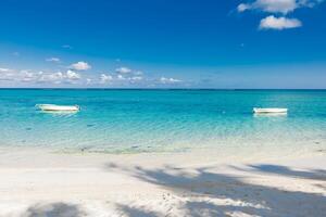 Tropical beach with transparent ocean and boat in Mauritius photo