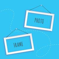 hanging photo frames on blue background vector