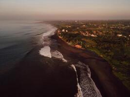 Aerial view of scenic beach with warm sunrise tones and ocean in Bali. Keramas beach photo