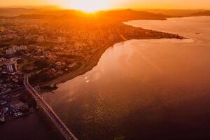 Cable bridge and downtown with sunset in Florianopolis, Brazil. Drone view photo