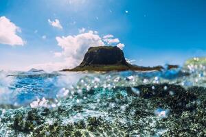 Tropical ocean water with Le Morne mountain in Mauritius photo