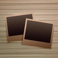 old photo frames on wooden background vector