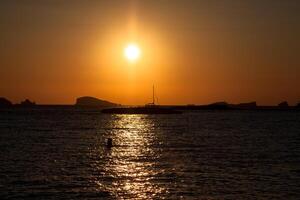 Sunset at the beach cala conta Ibiza,Spain photo