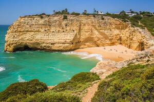 A view of beach in Benagil fishing village on coast of Portugal photo