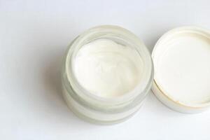 Moisturizing spf cream in a jar on a light background. photo