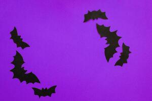 Paper bats on a purple background, Halloween concept photo