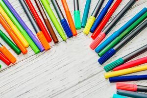 Stationery, colored felt-tip pens on a white table. photo