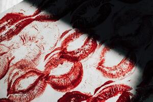 Imprint of red lips on white paper, kiss background photo