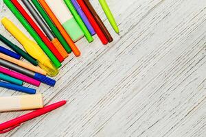 Stationery, colored felt-tip pens on a white table. photo