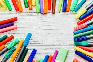 Stationery, colored felt-tip pens on a white table. photo