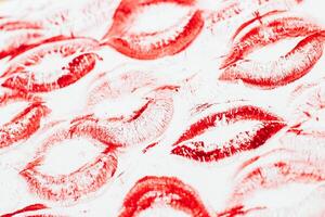 Imprint of red lips on white paper, kiss background photo