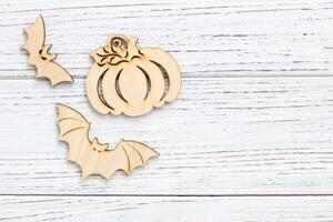 Wooden toy bat and pumpkin on a wooden background, Halloween concept photo