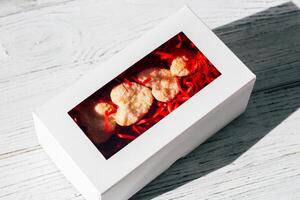 Homemade cookies in the shape of hearts are packed in a festive box photo