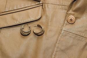 Decoration on the texture of a brown leather jacket, genuine soft leather. photo