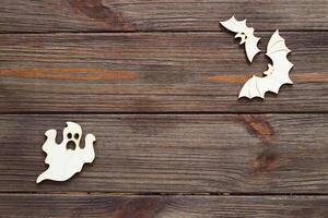 Wooden ghost toy on a wooden background, Halloween concept photo
