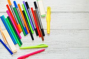 Stationery, colored felt-tip pens on a white table. photo