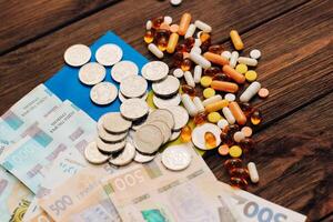 Ukrainian hryvnias with flag of Ukraine with pills and vitamins, healthcare concept photo