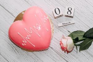 Pink tea rose with heart shaped pink mousse cake and February 14 calendar. photo