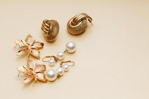 Gold ornaments from yellow metal on a light background. photo