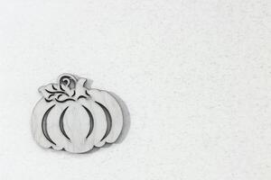Wooden toy pumpkin on white background Halloween concept photo
