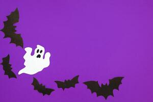 Paper bats on a purple background, Halloween concept photo