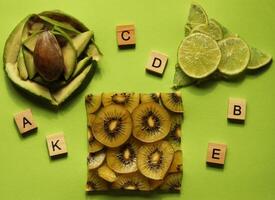 Sliced healthy food on green background. Vitamins photo