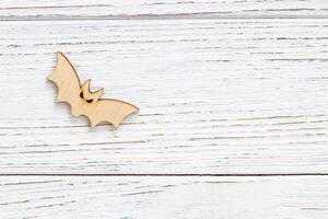 Wooden bat toy on a wooden background, Halloween concept photo