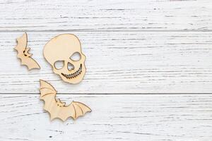 Wooden bat and skull toy on a wooden background, Halloween concept photo