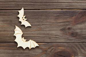 Wooden bat toy on a wooden background, Halloween concept photo