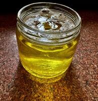 Pure homemade desi ghee in a glass container jar, extract ghee from milk malai photo