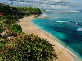 Tropical beach with ocean and waves in Bali island. Aerial view photo