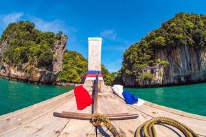 Aerial panorama of Thailand's verdant, lush tropical island, National Park Island, with blue and aquamarine the sea, and clouds shining by sunlight in the background. photo