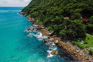 Scenic coastline with rocks, trees and blue ocean in Brazil. Aerial view photo