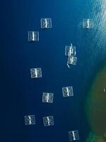 Fishing boats are at anchor in ocean on Sumbawa. Aerial view. photo