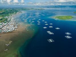 Local village and boats in ocean on Sumbawa island. Aerial view. photo