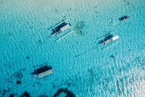 Boats are at anchor in ocean on paradise island. Aerial view. photo